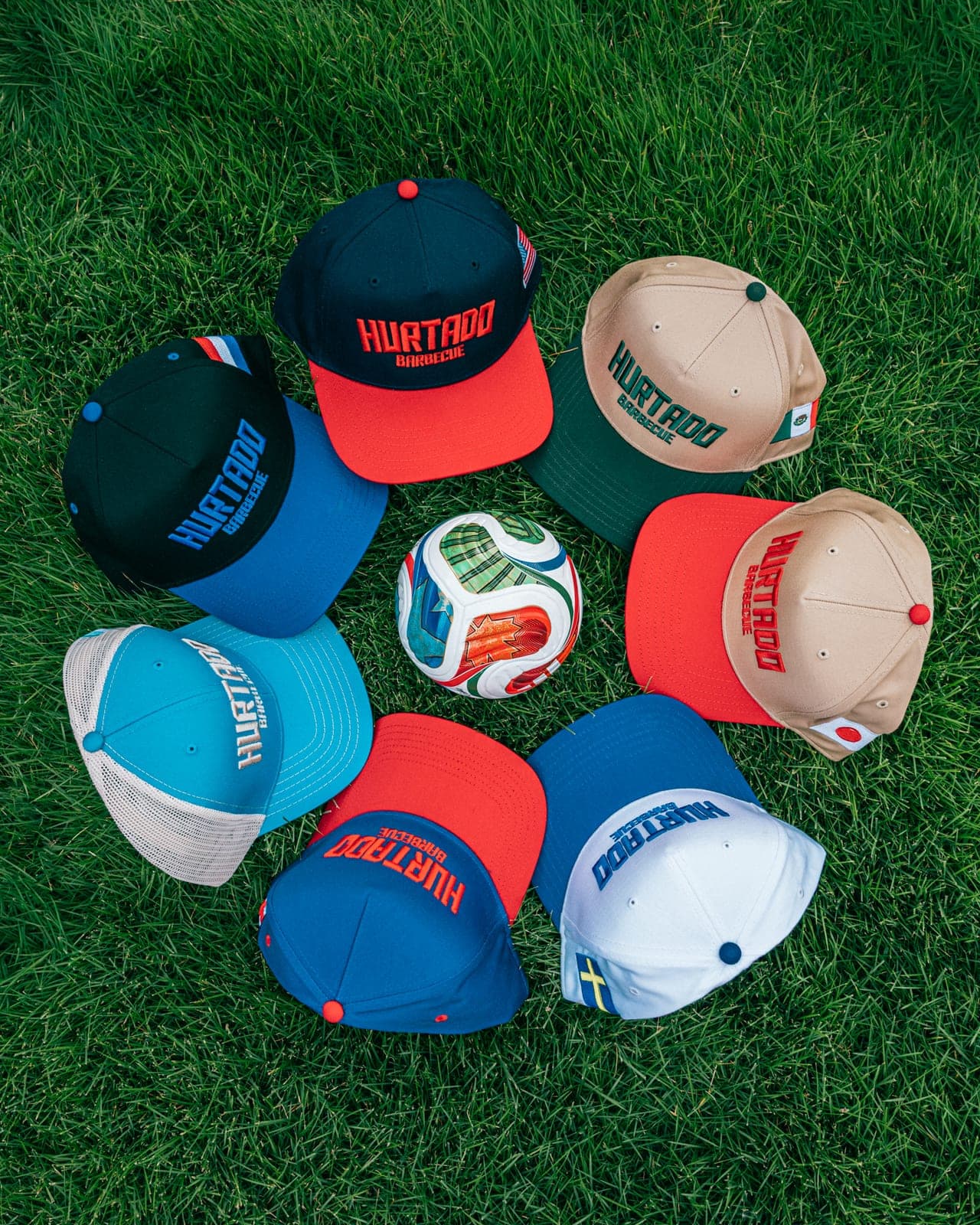 Hurtado Barbecue National Team Snapback collection flat-lay around a soccer ball